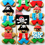 Chewy gingerbread men cookies decorated like pirates with glaze icing .