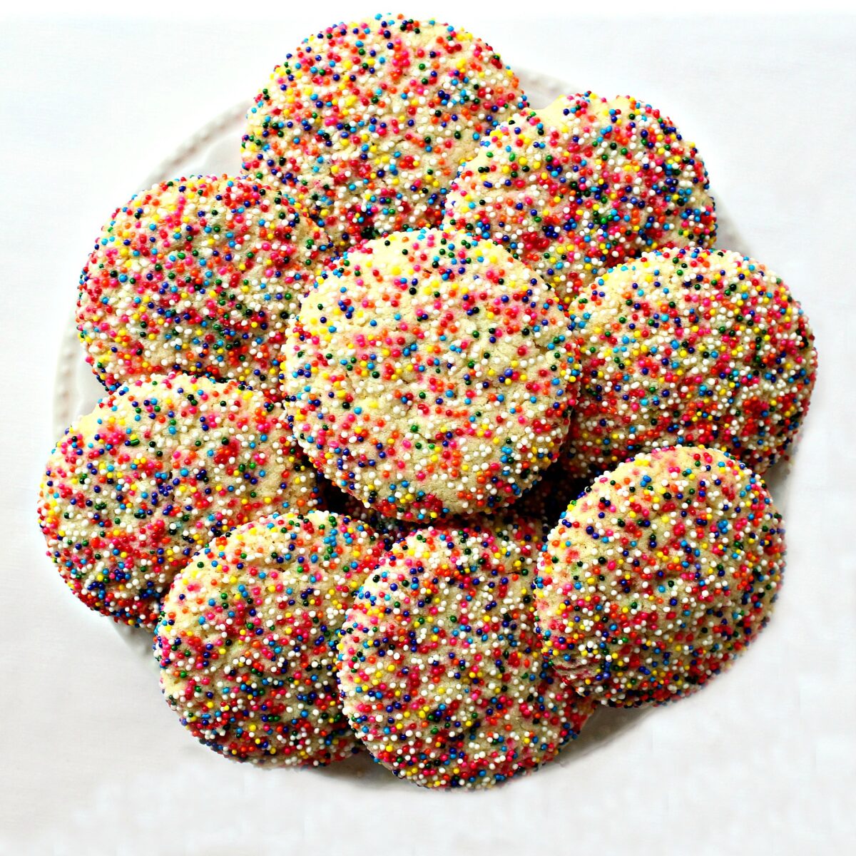 Sprinkle Sugar Cookies on a white serving plate.
