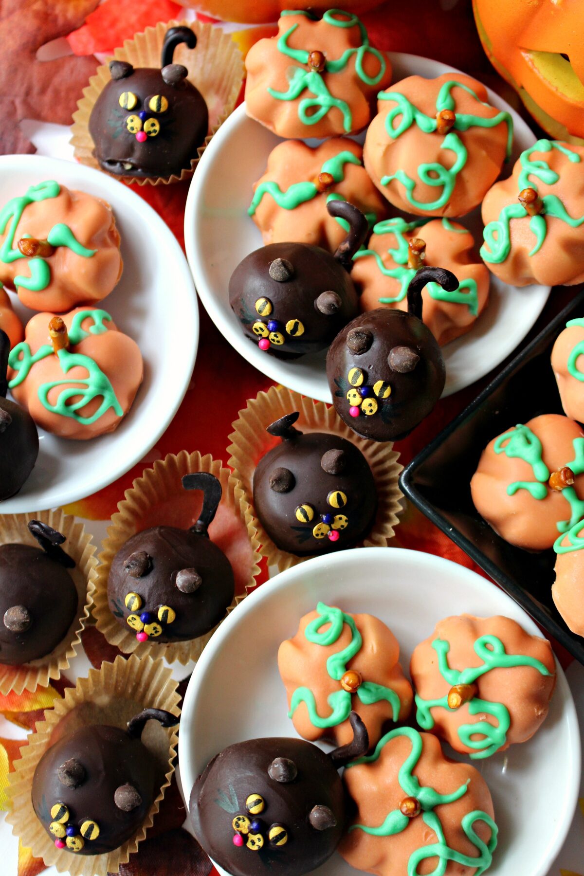  Peanut Butter Ball Pumpkins and Cats in little white bowls and in tan cupcake papers.
