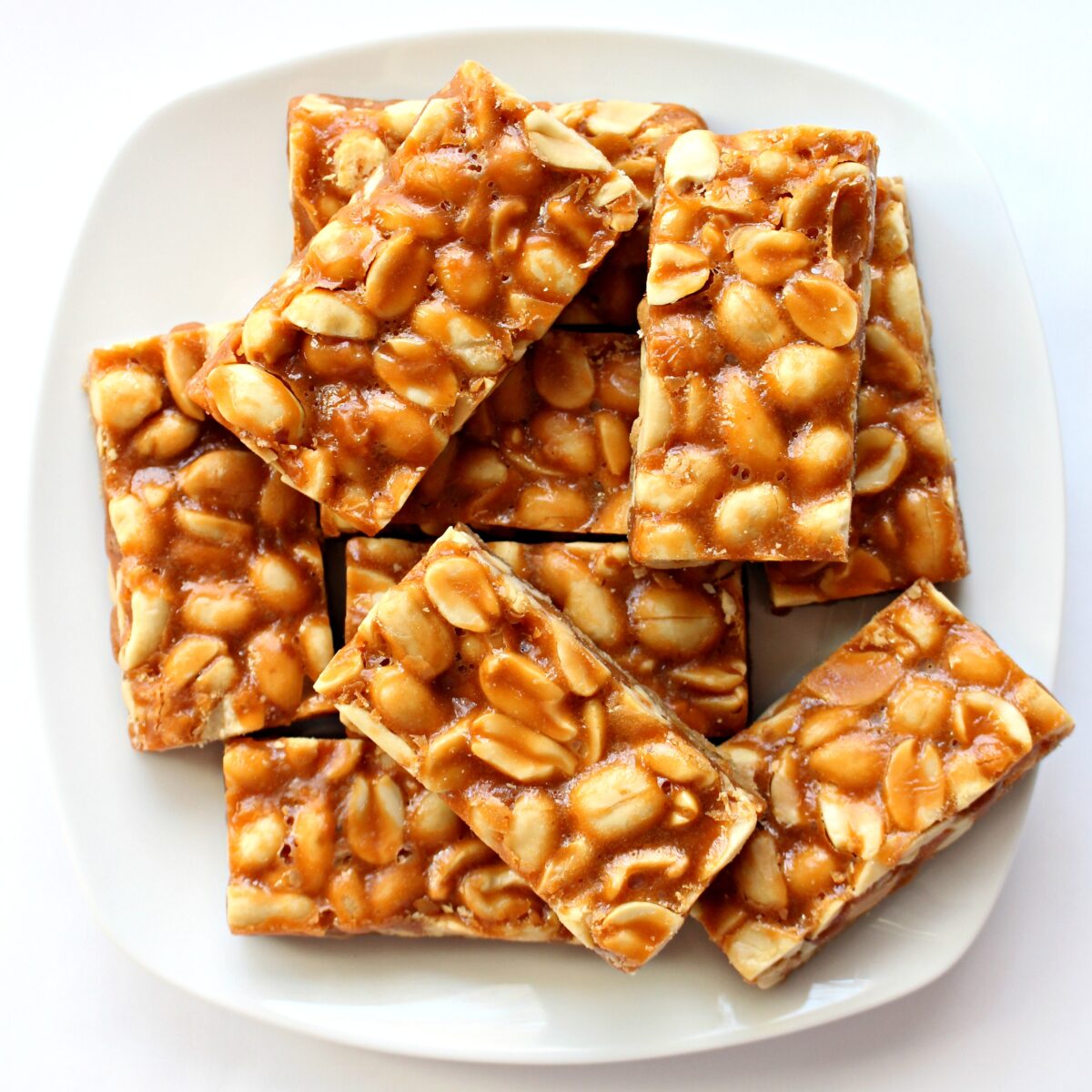  Peanut Bars on a square white plate.