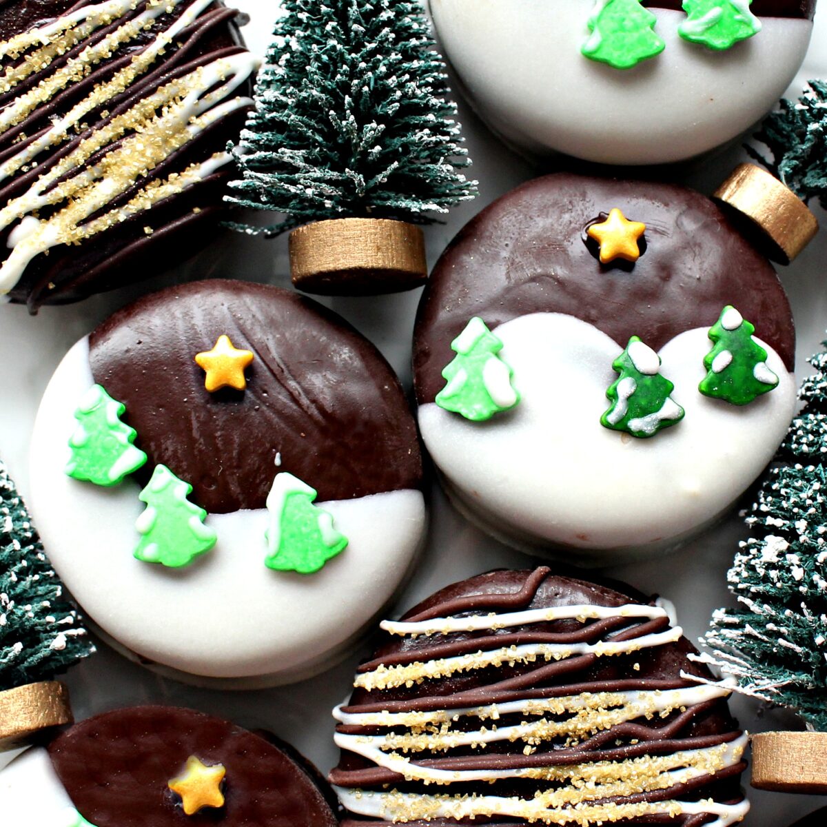 Closeup of  Chocolate Dipped Oreos with white chocolate dipped hillsides and shaped sprinkle trees and star.