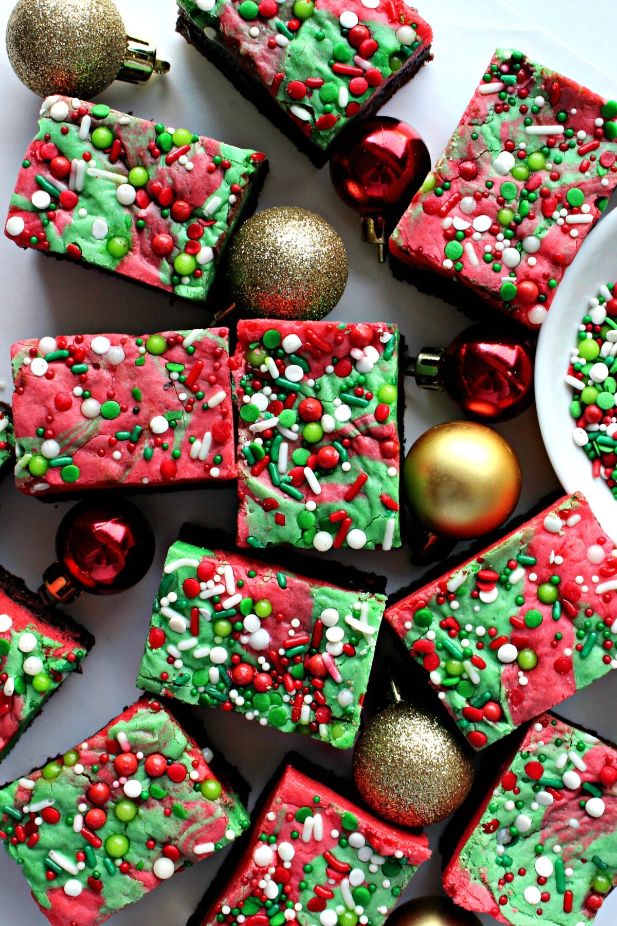 Christmas Brownies with red and green swirled blondie and sprinkles on top.