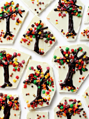 Closeup of white chocolate bark pieces with tree decorations.
