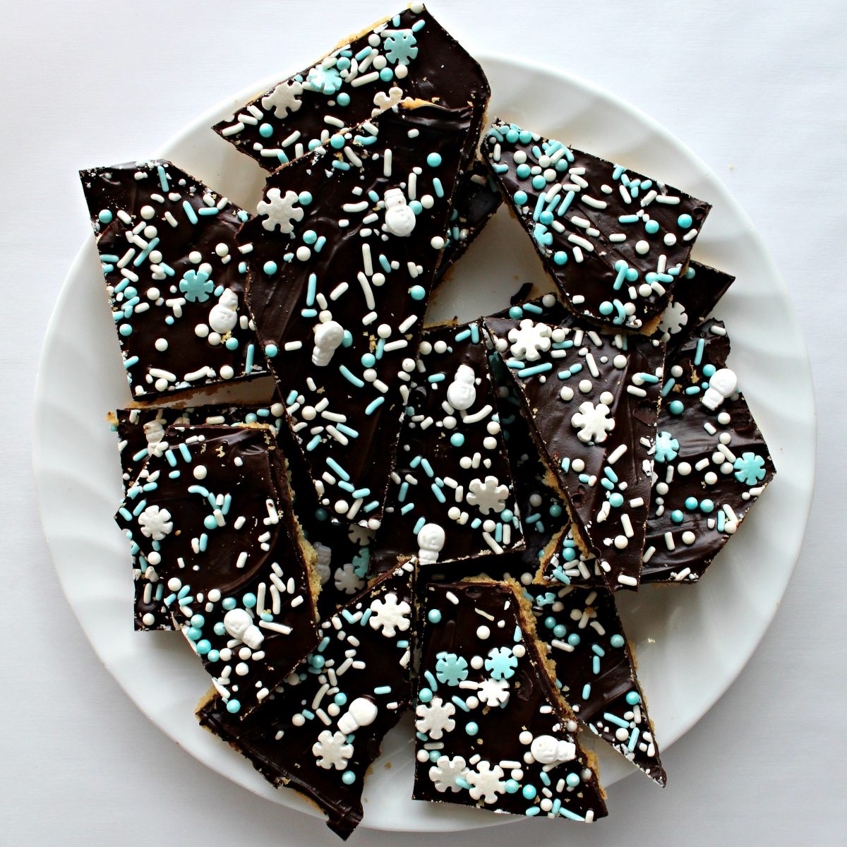 Dark chocolate Sugar Cookie Bark cut into individual servings on a plate.