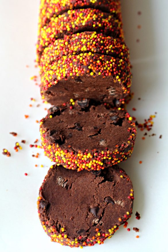 Spiced Chocolate Shortbread Cookies dough slices being sliced off the dough log.