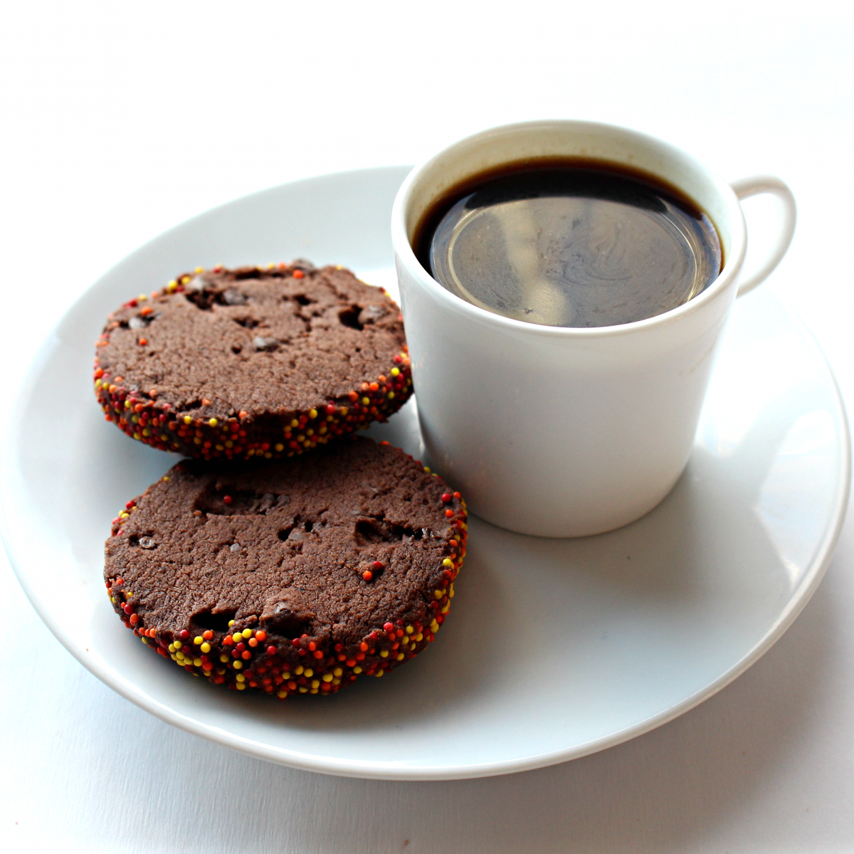 Spiced Chocolate Shortbread Cookies next to a cup of espresso.