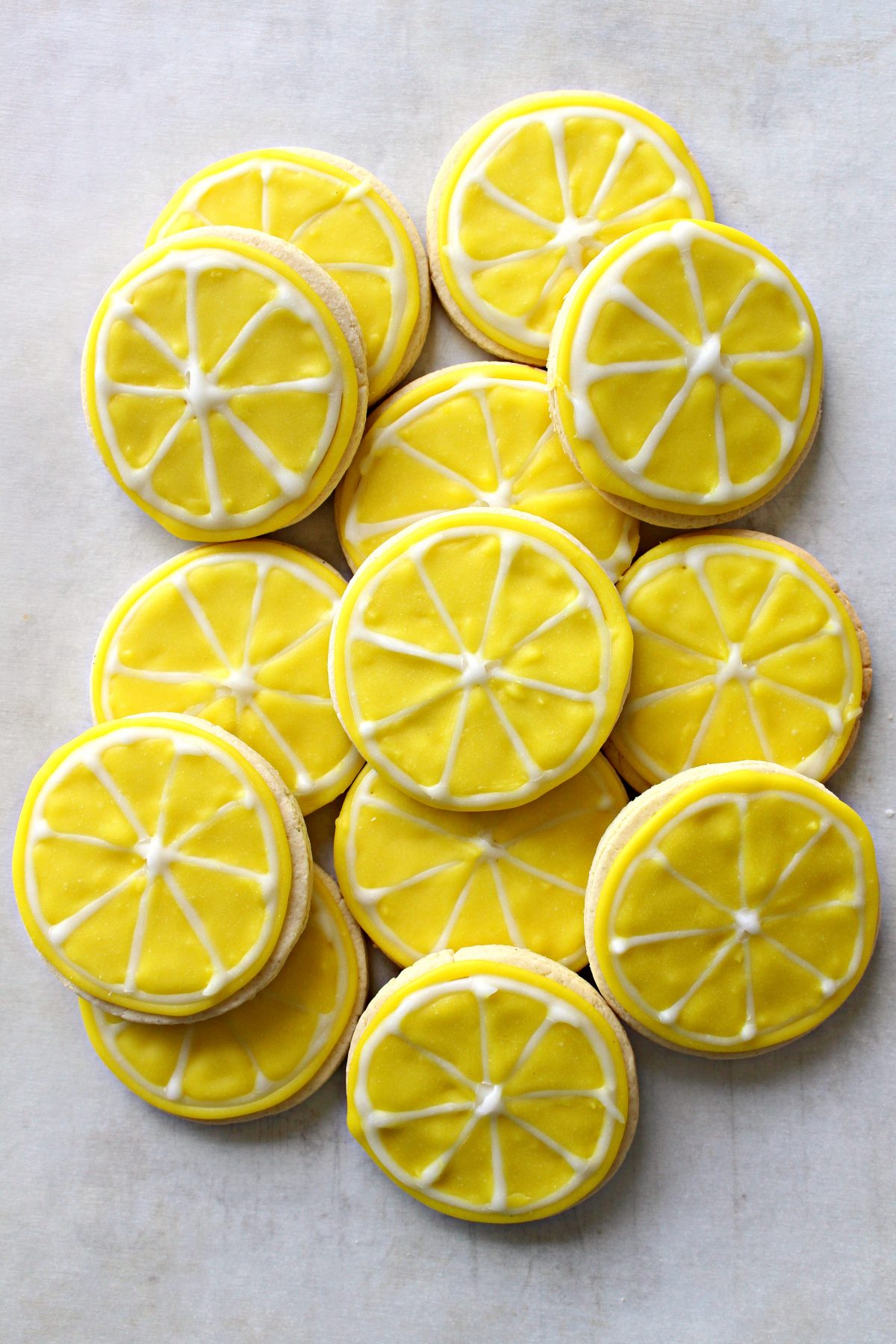 Sugar Cookie Lemon Slices look like sliced lemons, iced yellow with white icing segment lines.