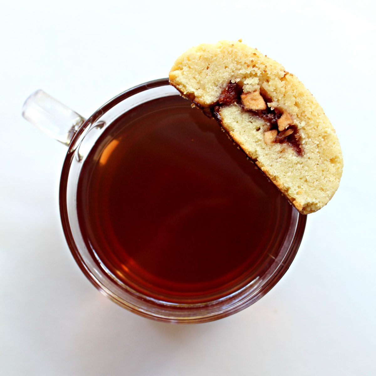 Overhead photo of tea mug with a cookie balanced on the rim.