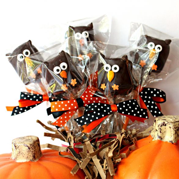 Owl Marshmallow Pops are a delicious treat and an adorable party favor, owl themed centerpiece, or care package surprise. Making owl marshmallow pops is fun and easy, a "hoot" for the whole family!| themondaybox.com #themondaybox#halloween #halloweentreats #owl #owls #partyfavors #showerfavors #chocolatecoveredmarshmallows five owl marshmallow pops wrapped individually in cellophane bags , tied with polka dot ribbons in black and orange.