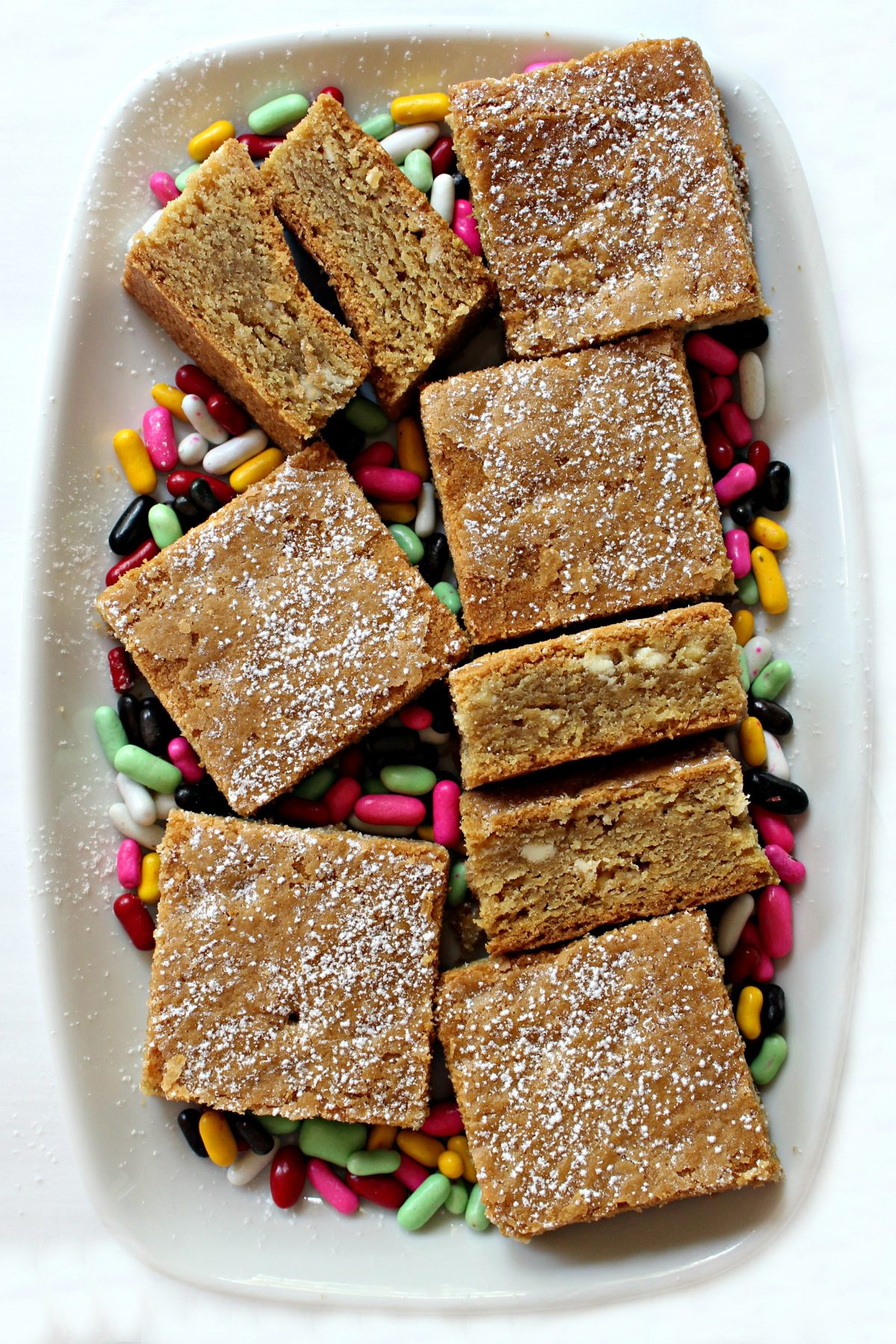 Root Beer Float Bars on a white platter with colorful licorice candies.