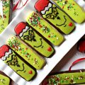 Diagonal photo of Decorated Grinch Cookies and Green Sprinkled Cookies on a white platter.