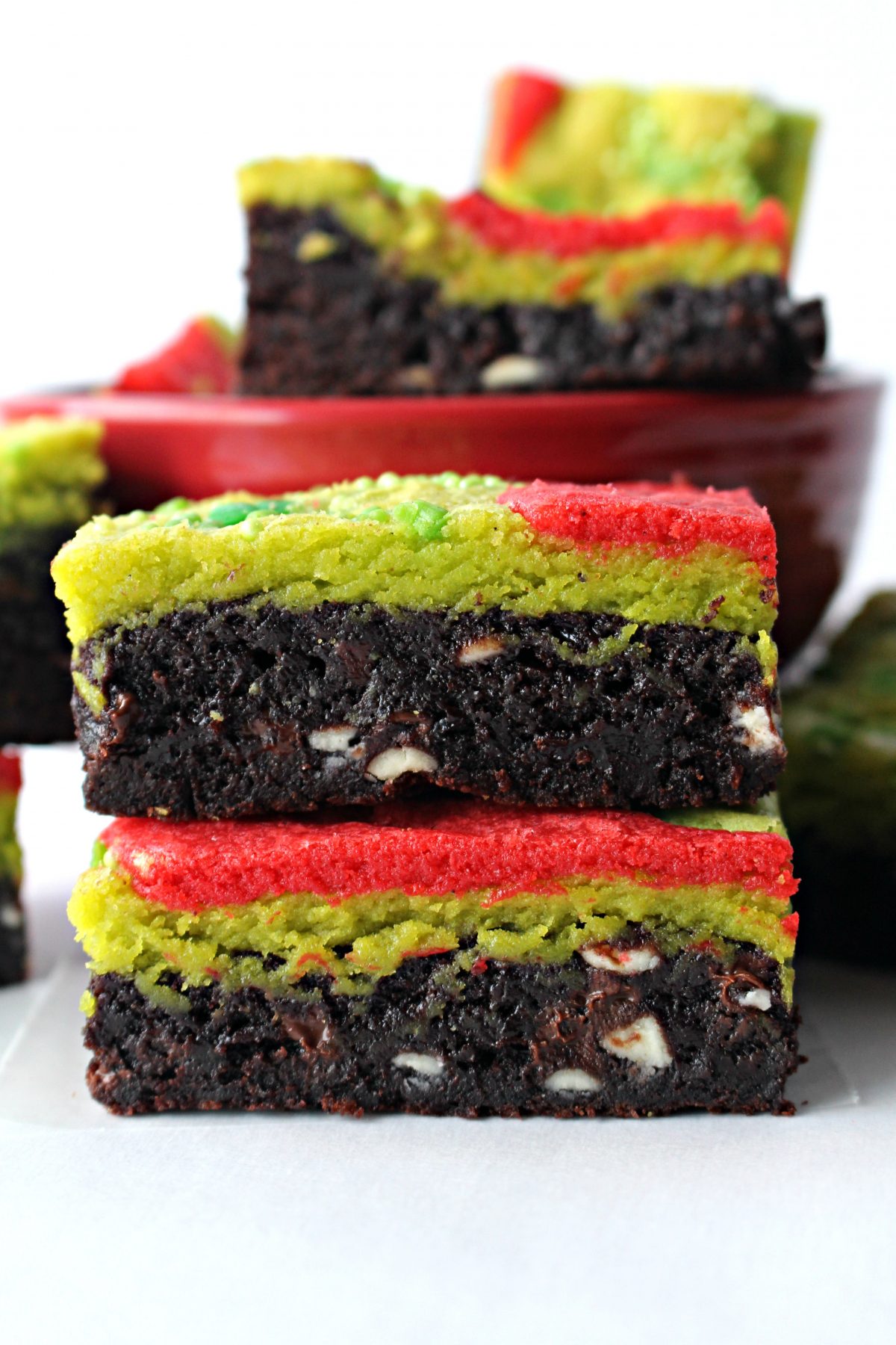 A stack of two Grinch Brownies, brownie on the bottom and green and red blondie on the top.