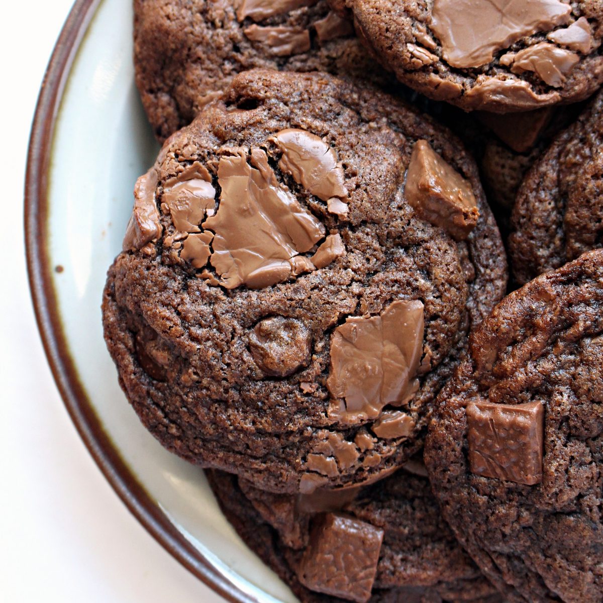 Closeup of Chocolate Chip Mocha Cookies topped with chunks of milk chocolate.