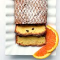 Closeup of Orange Olive Oil Cake sliced on a platter