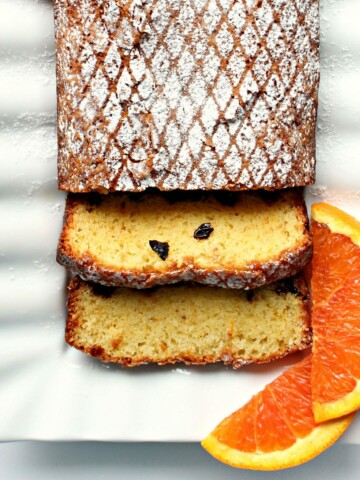 Closeup of Orange Olive Oil Cake sliced on a platter