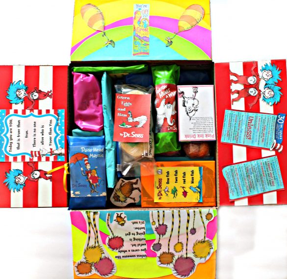 The inside of the care package with the flaps of the box decorated from Seuss books. 