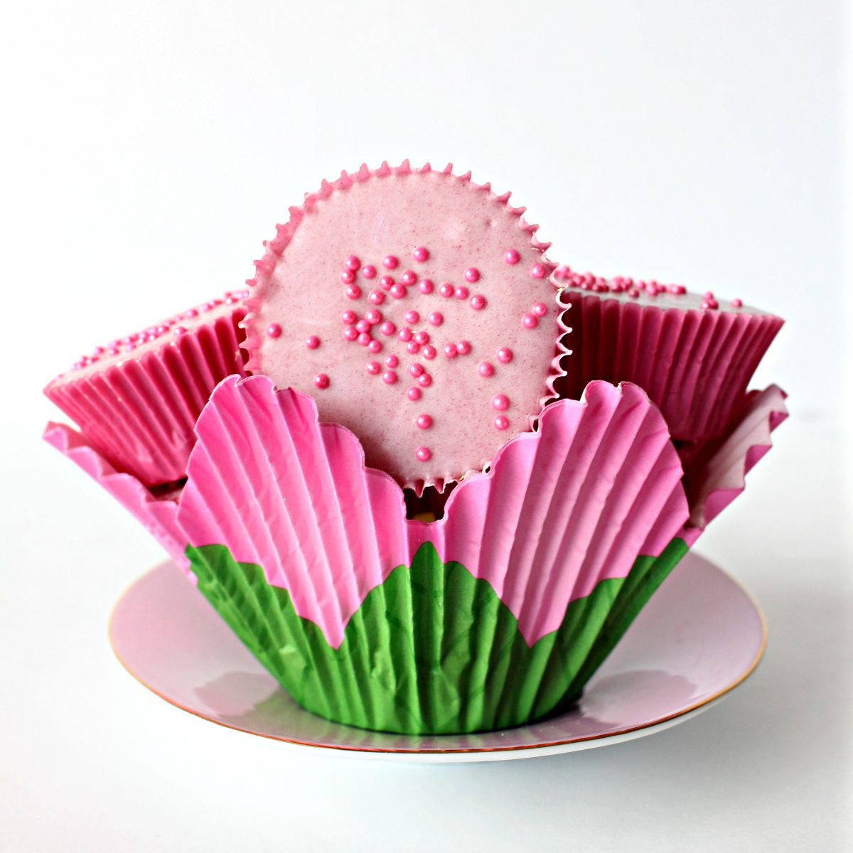 Pink peanut butter cups in flower shaped cupcake liner.