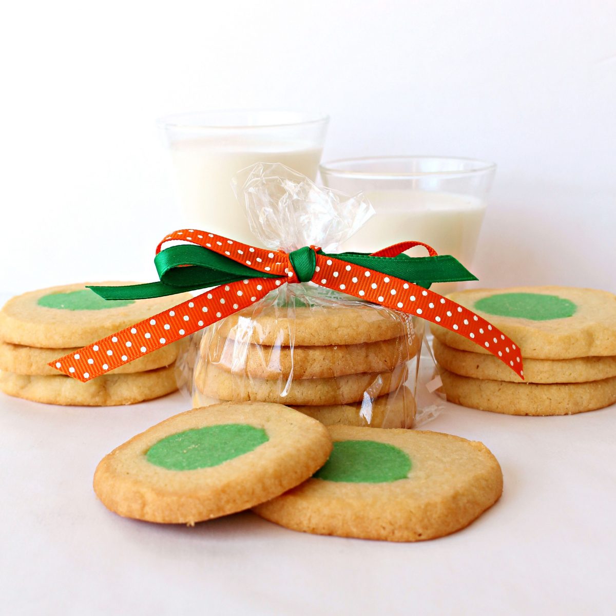 Green Eggs and Ham Cookies in a plastic bag tied with green and orange ribbon.