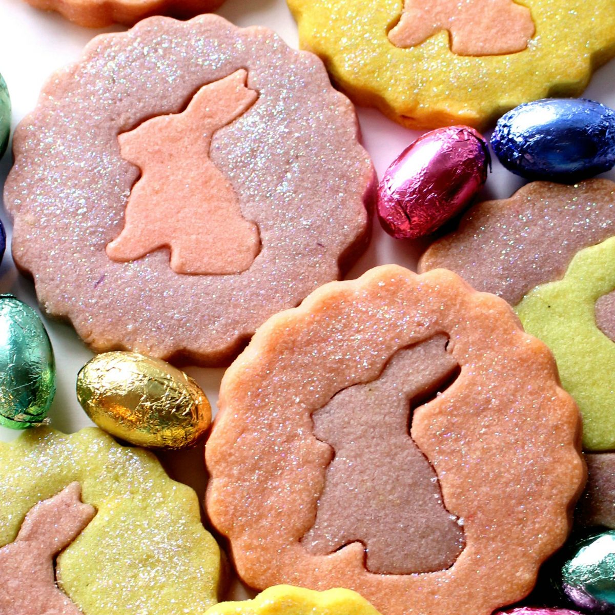 Closeup of bunny silhouettes inset onto contrasting colored shortbread cookies.