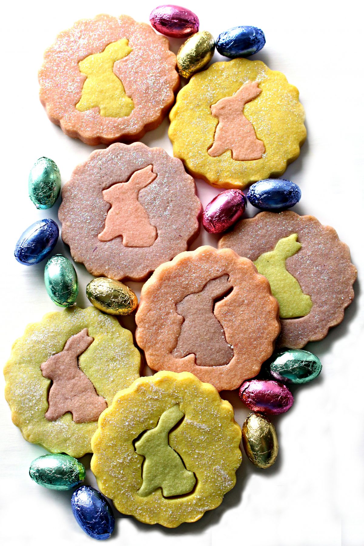 Pastel colored shortbread cookies with rabbit silhouette cutout centers.