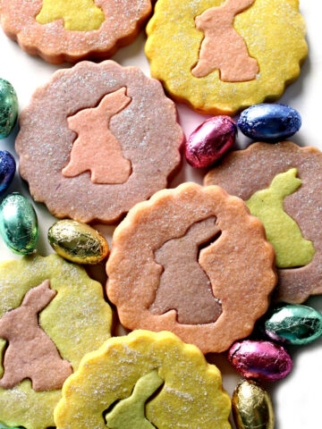 Pastel shortbred cookie circles with cutout bunny centers.