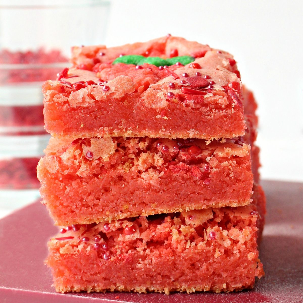 Stack of three bright pink, strawberry brownies.