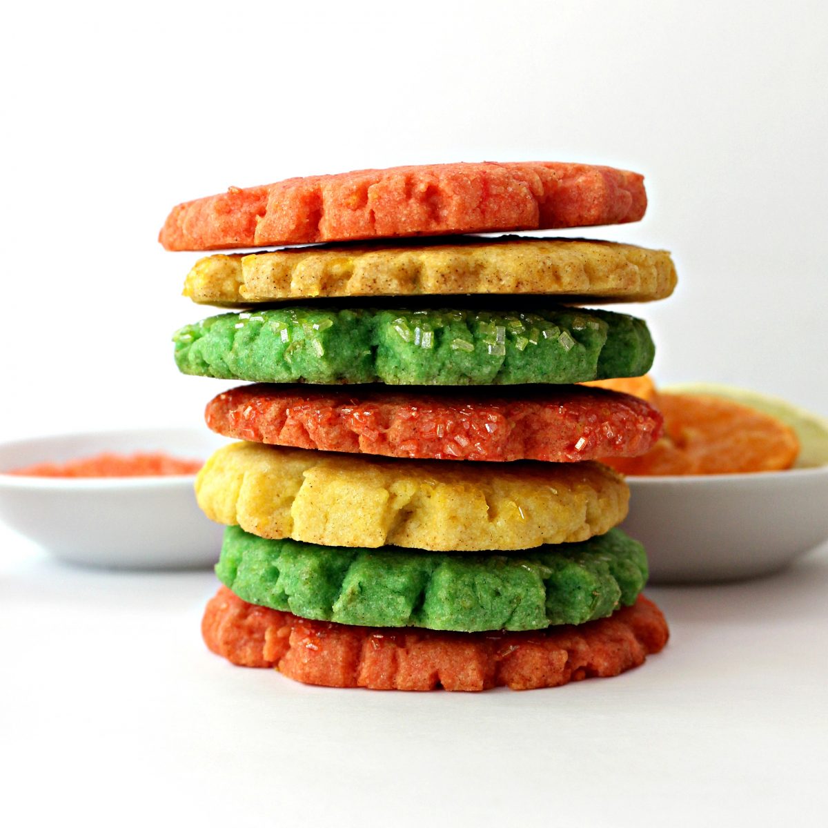 Stack of yellow , green, and orange Mexican Sugar Cookies.
