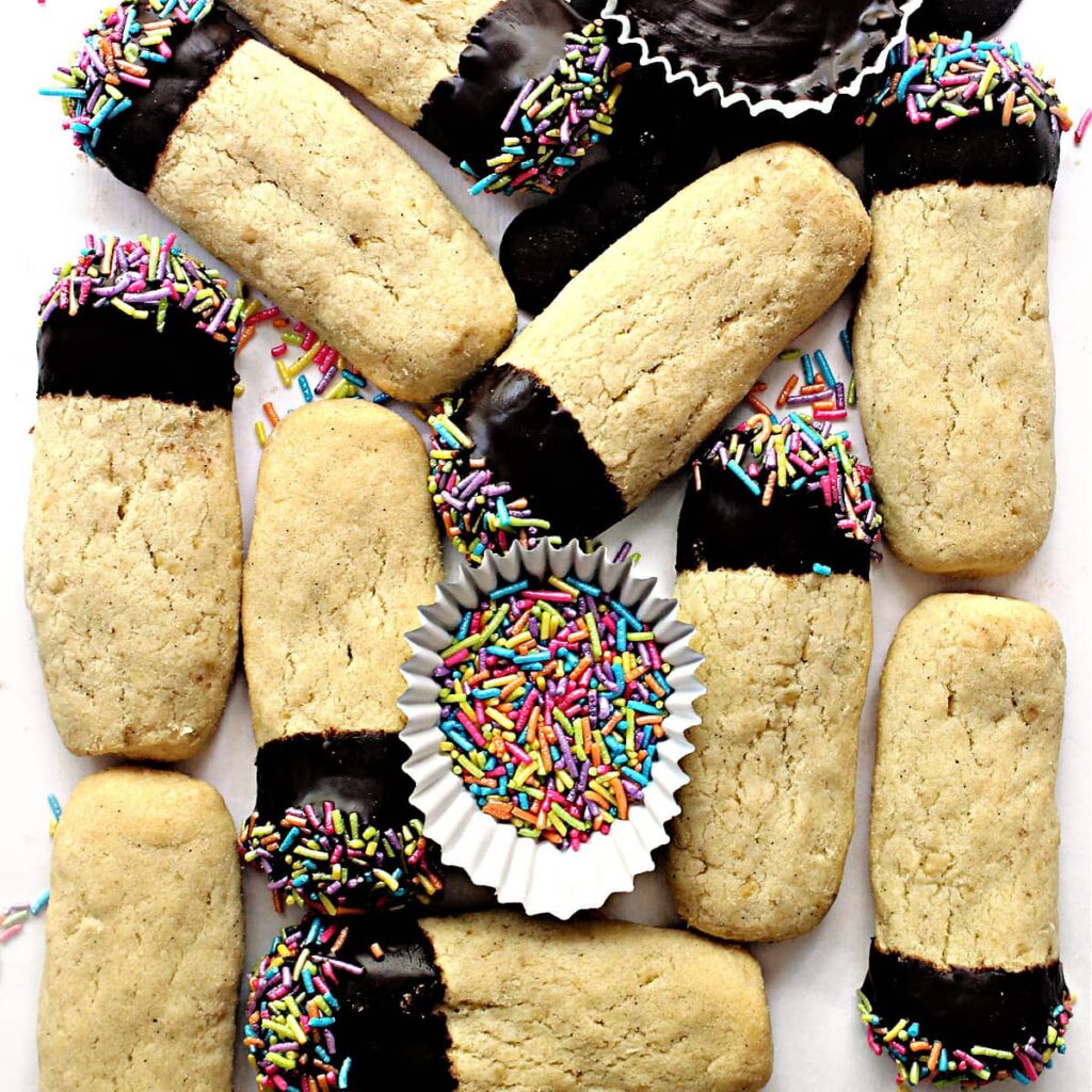 Finger shaped shortbread cookies with chocolate dipped ends and sprinkles.