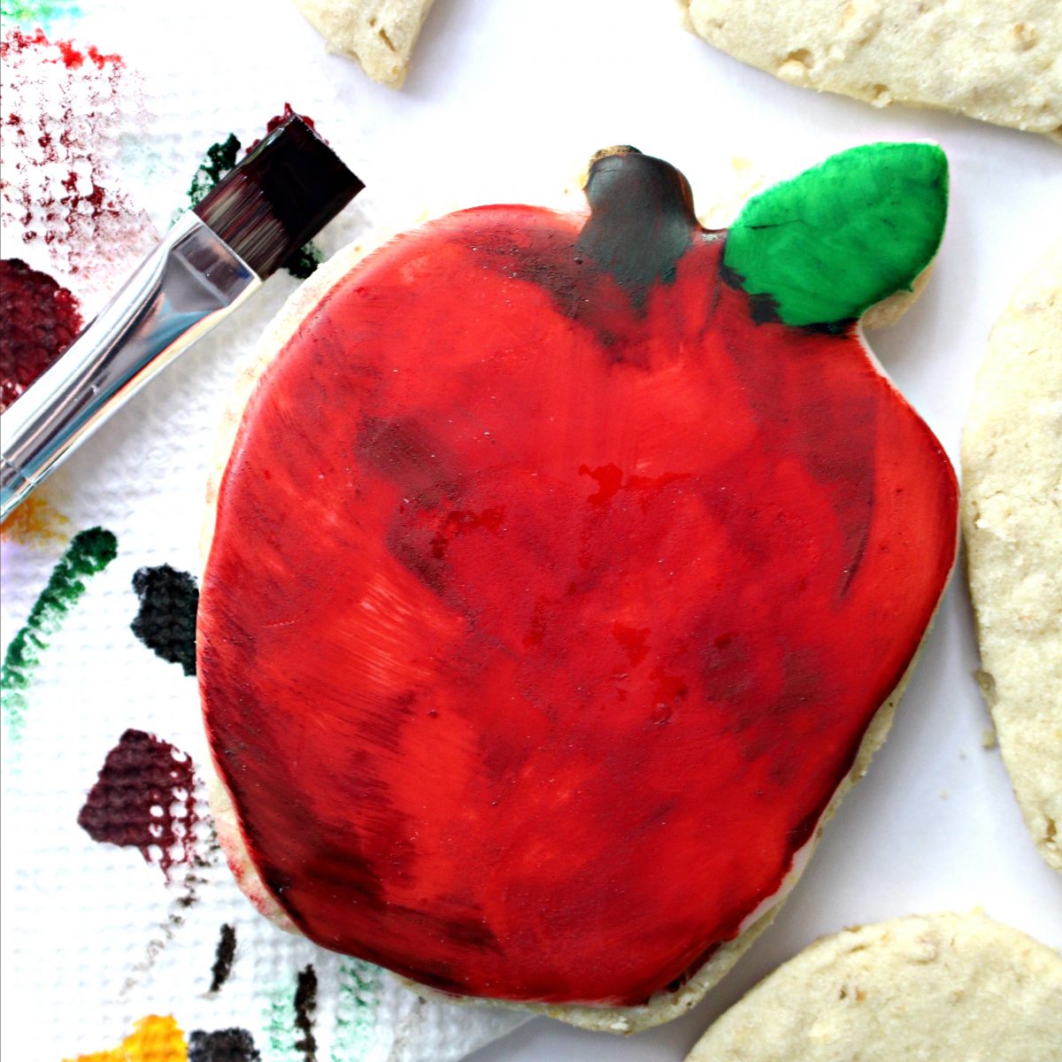 Apple cookie with brush for painting on color.