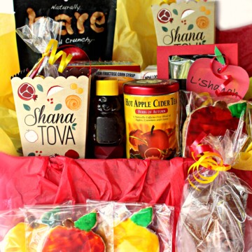 Rosh Hashanah gift care package box filled with homemade and purchased gifts with apples and honey flavors.