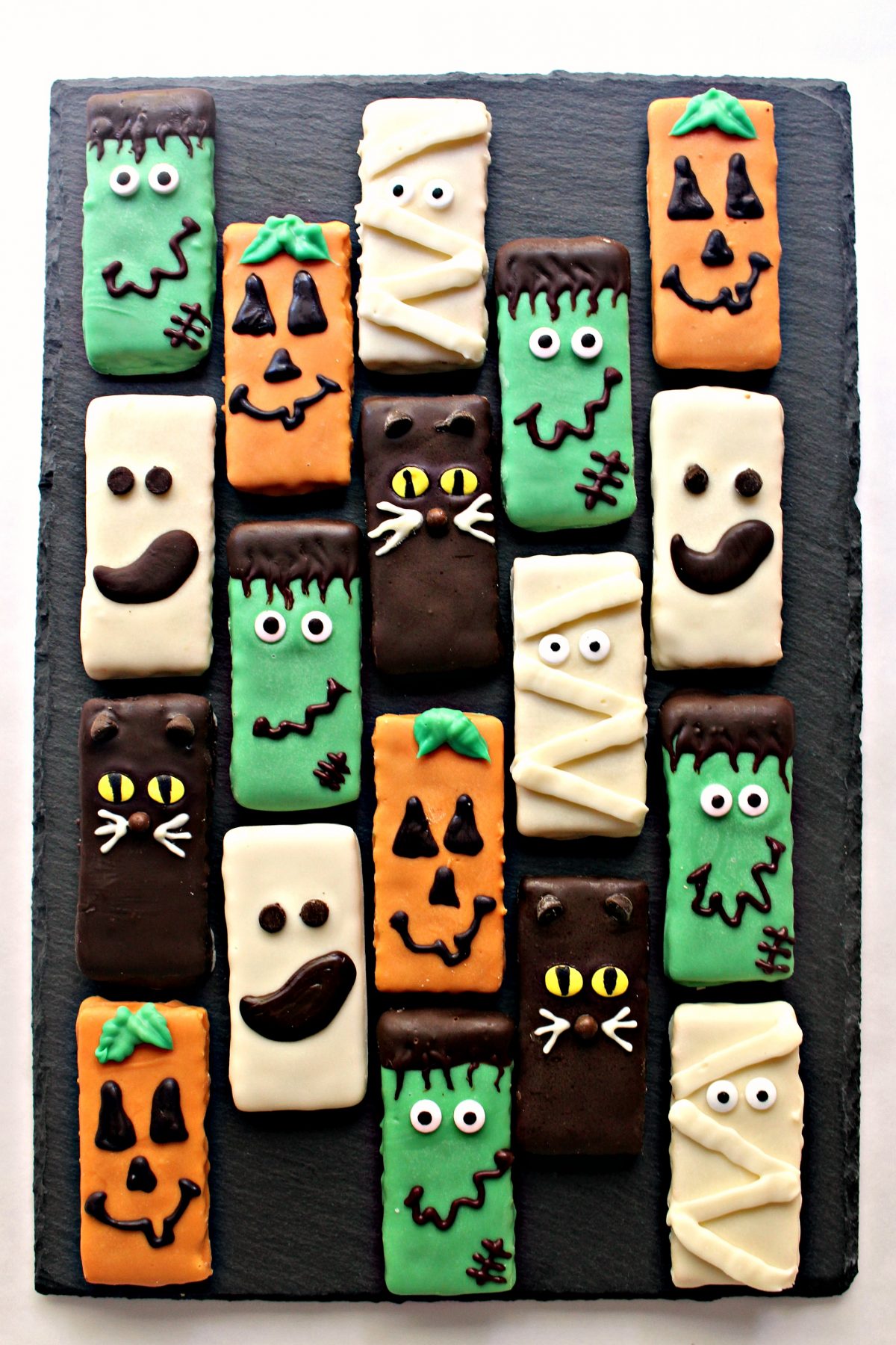 Chocolate coated graham Crackers decorated as Frankenstein, Pumpkin, Ghost, Mummy, and Cat.