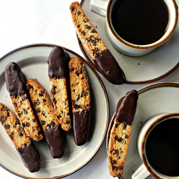 biscotti on plates with cups of coffee