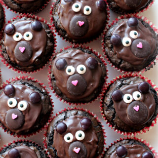 Closeup of brownie cupcakes decorated like bears.
