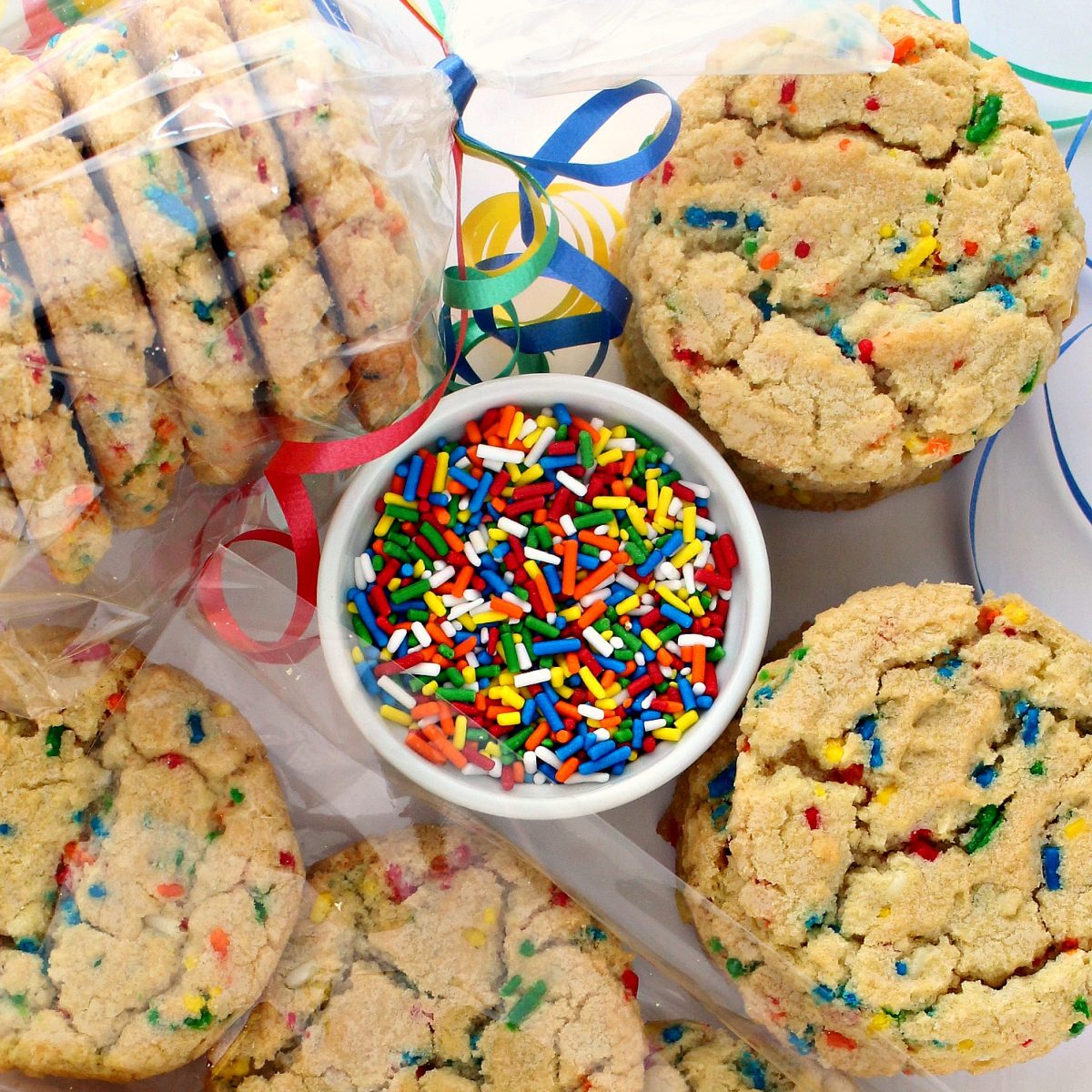 Cookies and a bowl of elongated, rainbow colored jimmies sprinkles.