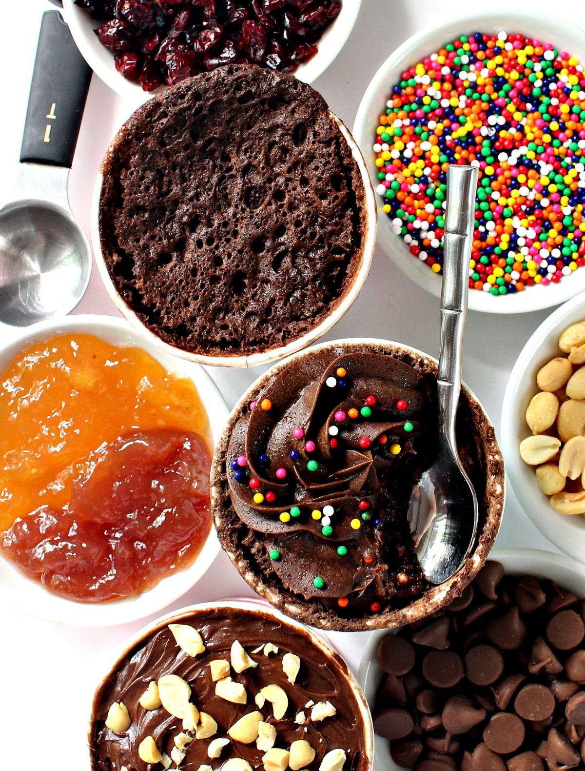 A table topped with plates of food on a plate, with Mug cake