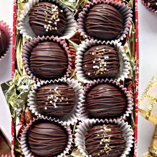 Chocolate covered marzipan balls candy in a gift tin