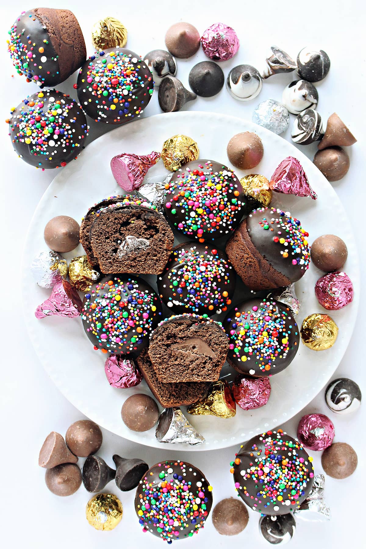 Chocolate kisses and ball shaped Secret Kiss Cookies dipped in chocolate with multicolored nonpareils. 