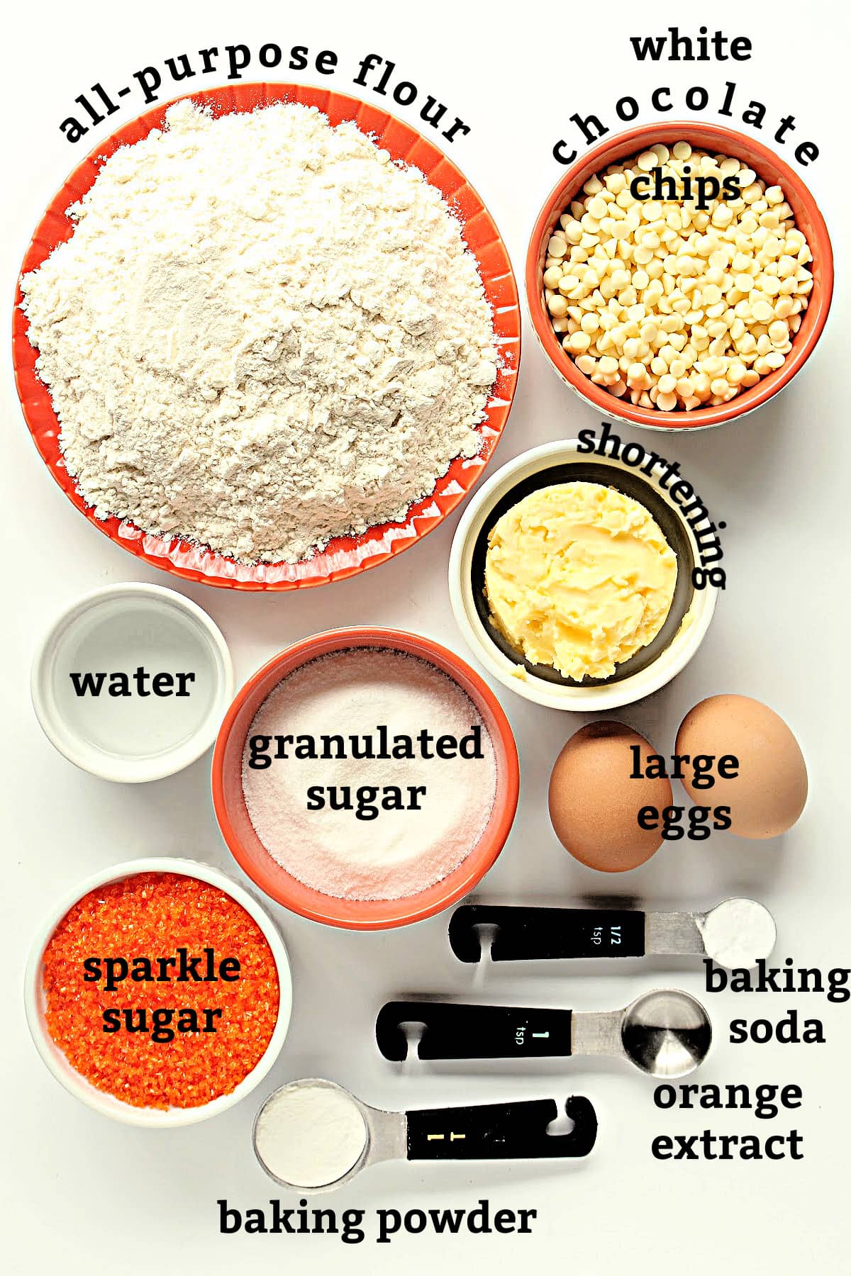 Recipe ingredients; flour, white chocolate chips, shortening, water, sugar, eggs, baking soda, baking powder, orange extract.