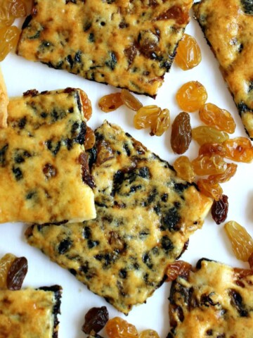 Closeup of raisin biscuit squares with golden crust speckled with raisins.