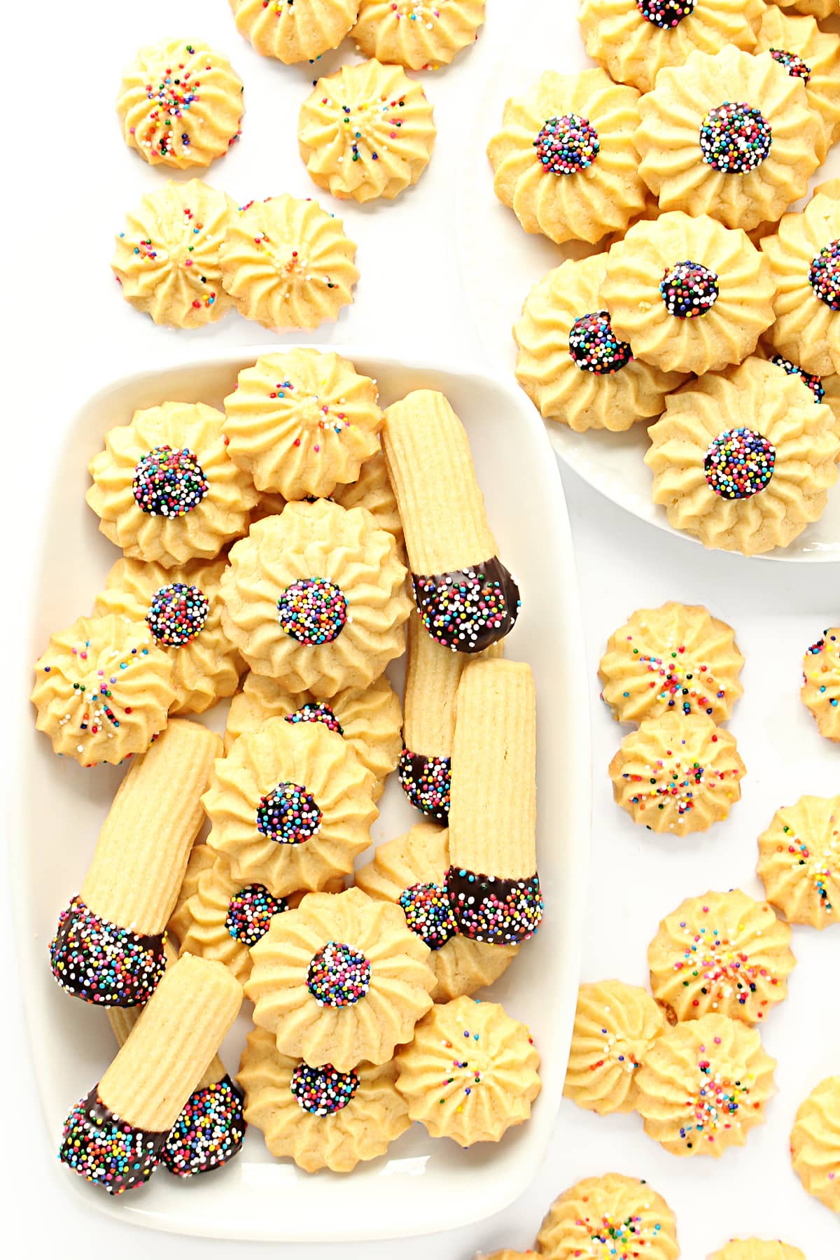 Piped butter cookies topped with multicolored nonpareil sprinkles.