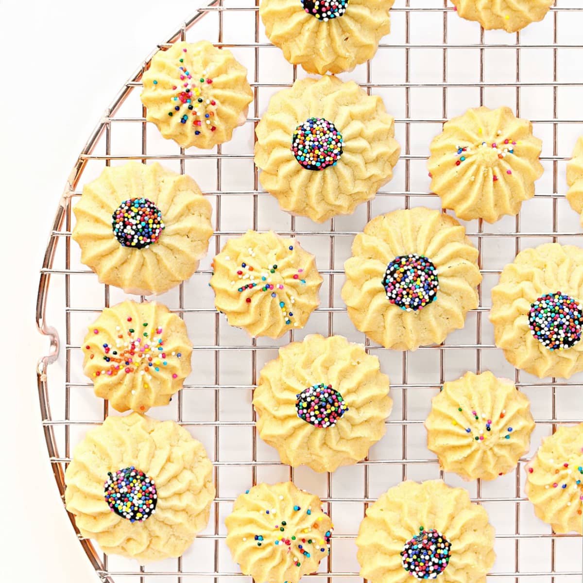 Sprinkle decorated cookies on wire cooling rack.