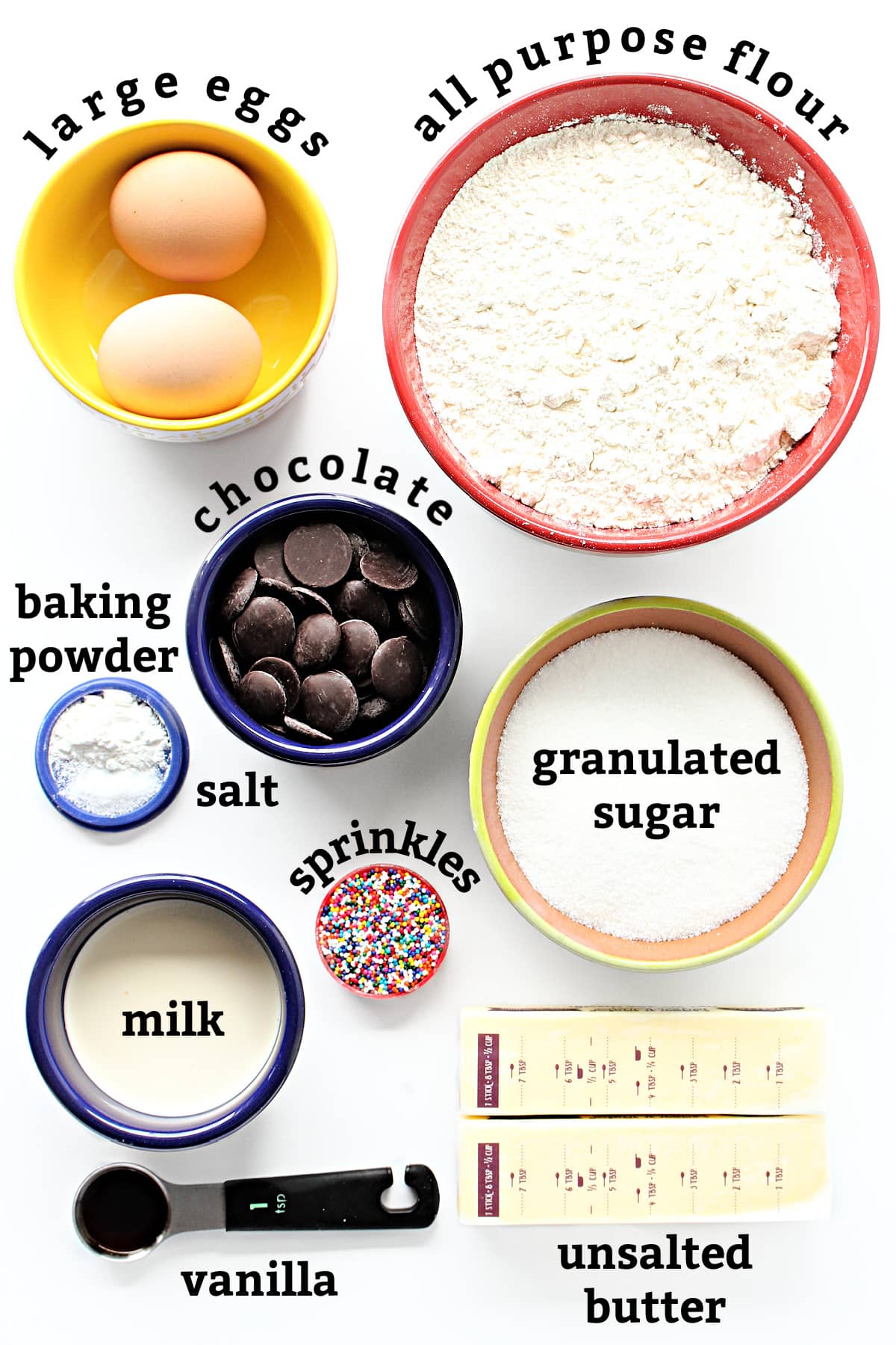 Ingredients with text labels: eggs, flour, baking powder, salt, chocolate, milk, sprinkles, sugar, butter, vanilla.