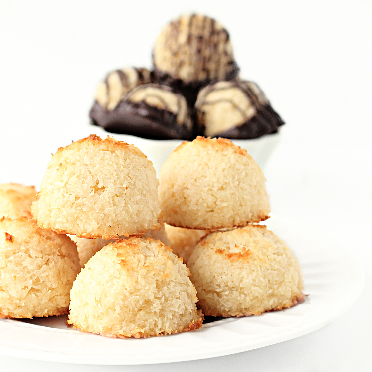 Plain coconut macaroons on a white plate.