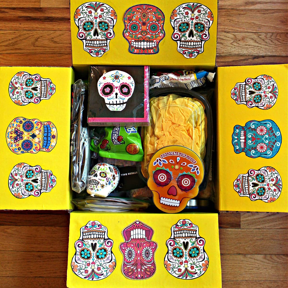 Dia de los Muertos box decorated with skulls and filled with goodies.