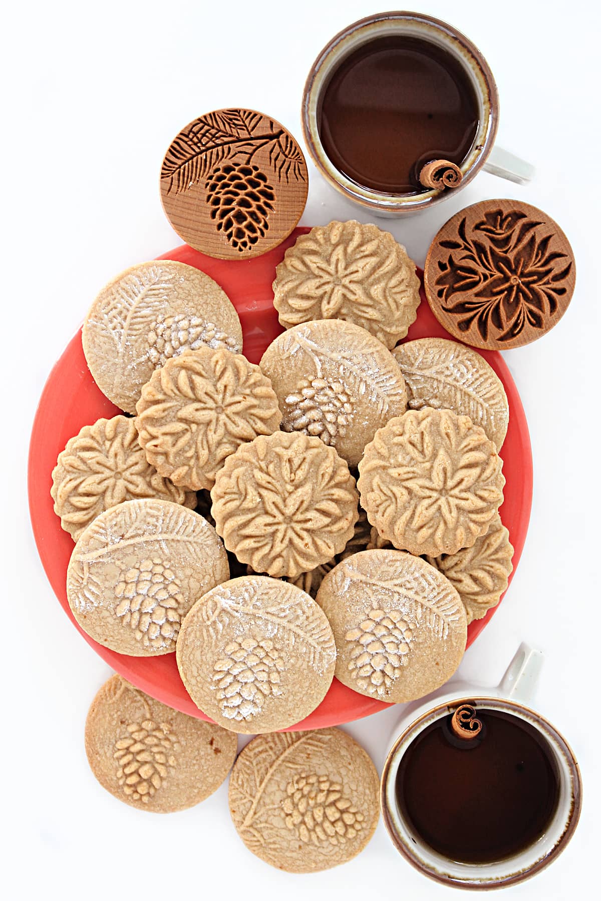 Apple Cider Cookies stamped with flower and pine cone designs.