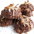 Domed chocolate coconut cookies topped with coconut.