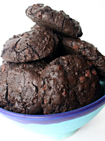 Thick, dark chocolate brownie cookies in a blue bowl.