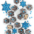 Chocolate covered peanut butter candy in star shapes with Hanukkah sprinkles.