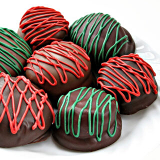 Chocolate covered marshmallow cookies with red and green drizzle.