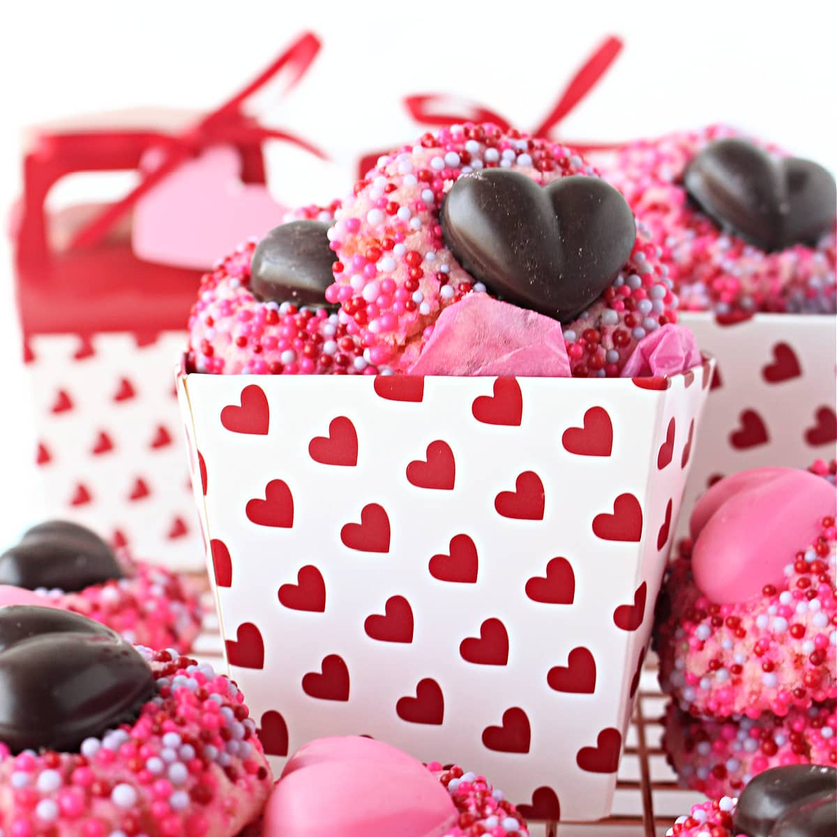 Closeup of a cookie in a gift box decorated with hearts.